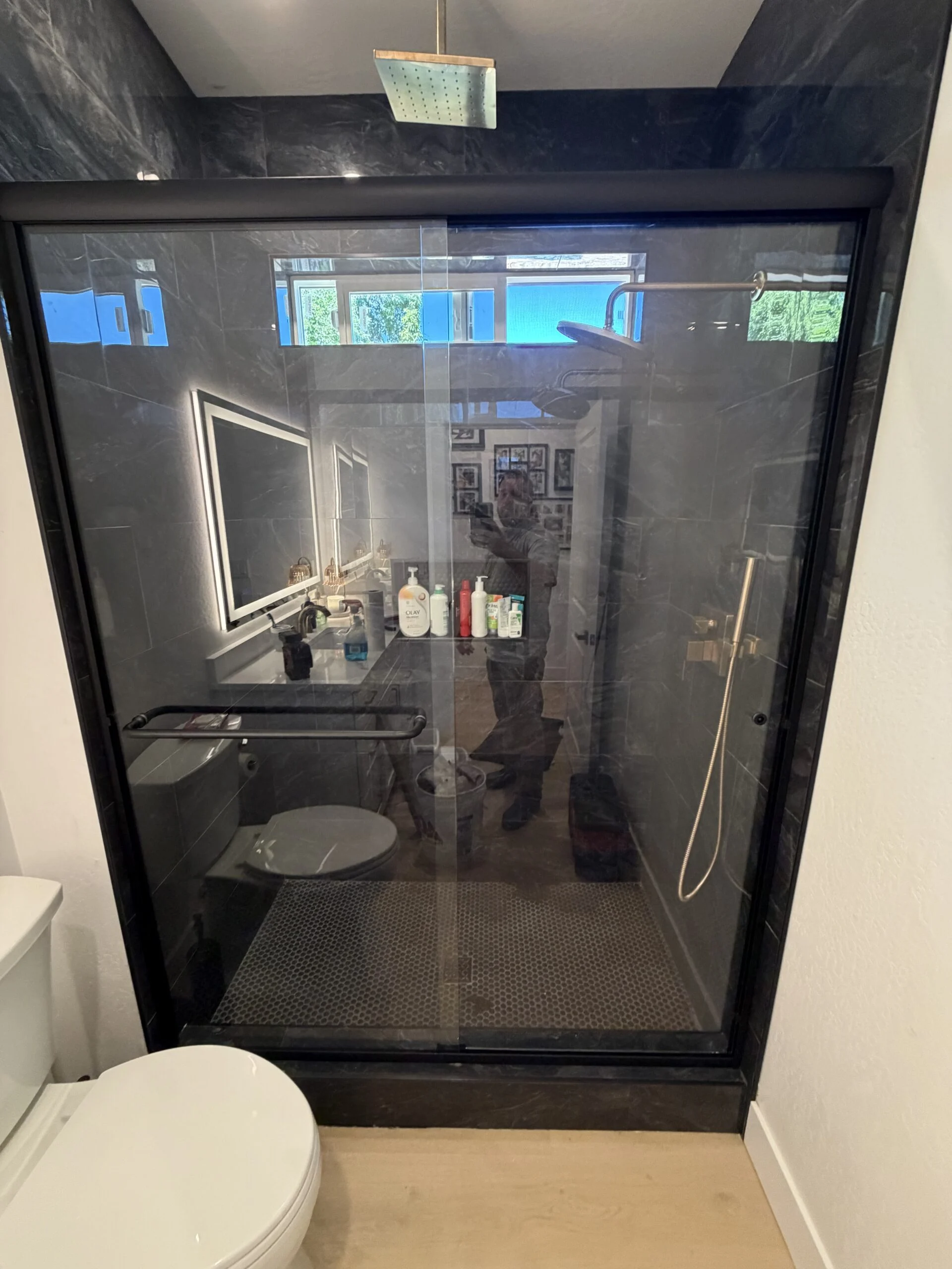 Black-framed glass shower enclosure in a modern bathroom