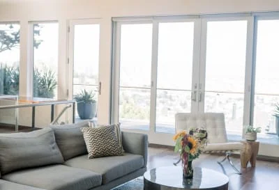 Bright Living Room Gray Sofa Wall Glass Bright living room with gray sofa and a wall of glass doors