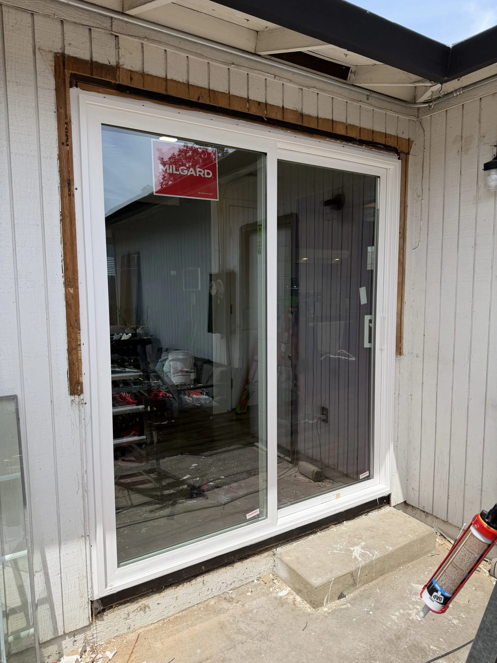 New white sliding patio door in a home exterior wall