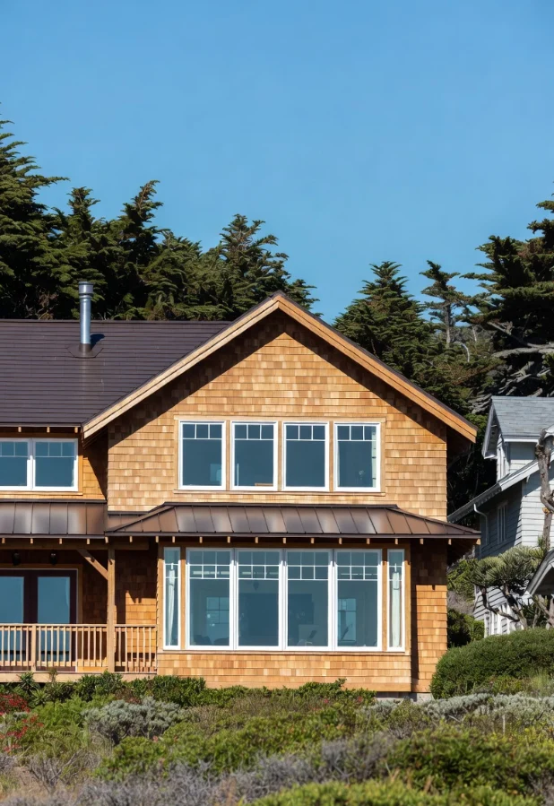 Shingled two-story house with rows of windows